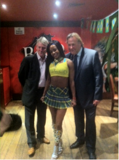 Alan Rough and Frank McAvennie with one of the dancers at the launch of the Brazilian National Tartan at Boteco do Brasil in Glasgow